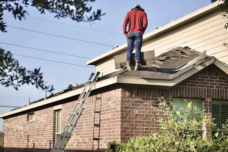 Professional roofer working on a residential roof in Laurel Hill